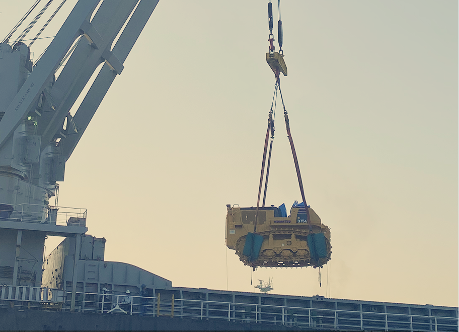 Heavy-lift operation of Komatsu D375A bulldozer, demonstrating strength and expertise